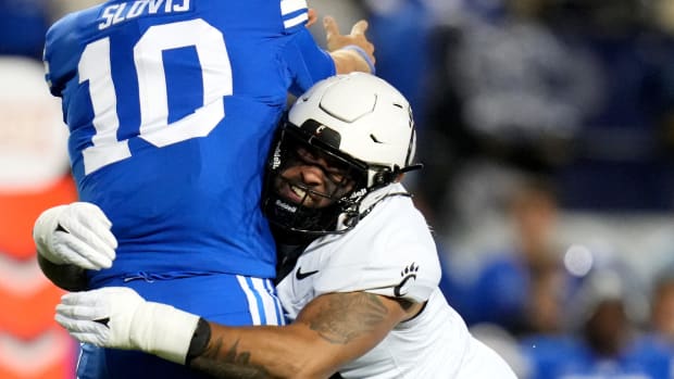 Cincinnati Bearcats defensive end Justin Wodtly (95) pressures Brigham Young Cougars quarterback Kedon Slovis (10) as he throws in the second quarter during a college football game between the Brigham Young Cougars and the Cincinnati Bearcats, Friday, Sept. 29, 2023, at LaVell Edwards Stadium in Provo, Utah.